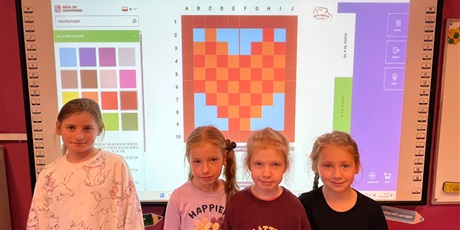 Powiększ grafikę: Dzieci prezentują ułożone piksele.