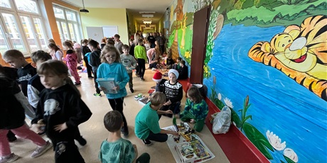 Powiększ grafikę: Uczniowie na holu wymieniają się przyniesionymi przedmiotami.